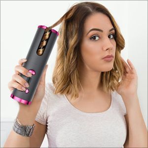 Woman using a hair Curler tool to style her hair.